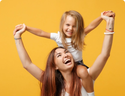 mother with daughter on her shoulder laughing playing daughter is experiencing nutritional gaps that mother wants to supplement